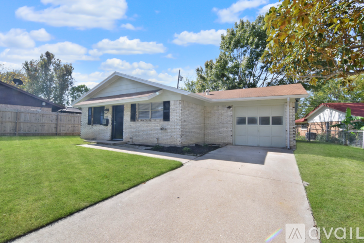 A house with a white garage door and a brown roof.