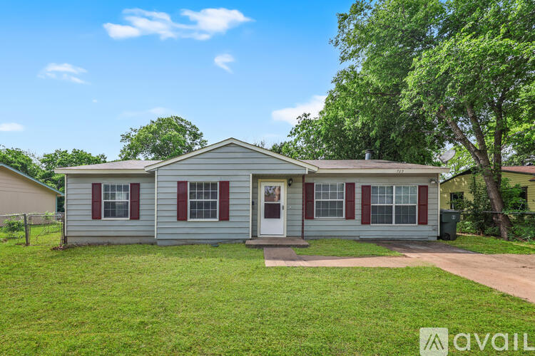 A house with red and white trim is for sale.