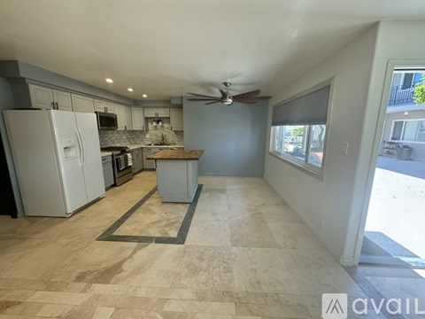 A kitchen with a refrigerator, stove, and oven.