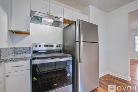 A kitchen with a stainless steel refrigerator and oven.