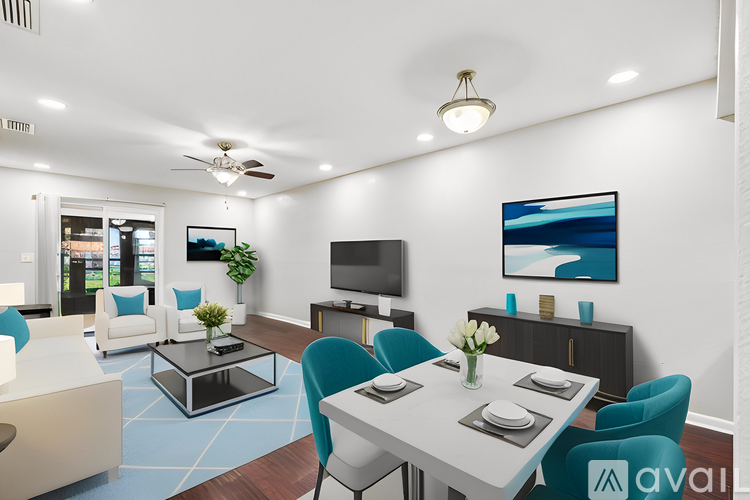 A modern living room with a white dining table and blue chairs.