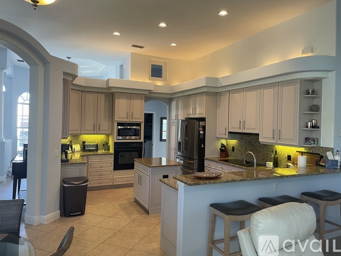 A kitchen with a black refrigerator and stove.