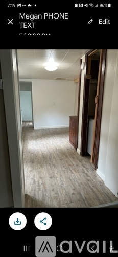 A room with wooden flooring and white walls.