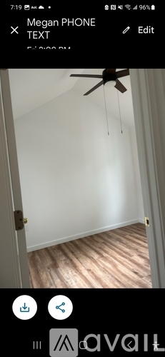 A room with wooden flooring and a ceiling fan.