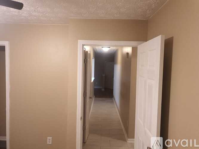 A room with a white door and a light on.