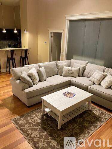A living room with a large couch and a coffee table.