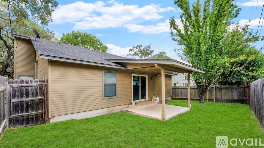 A house with a beige exterior and a covered patio area.