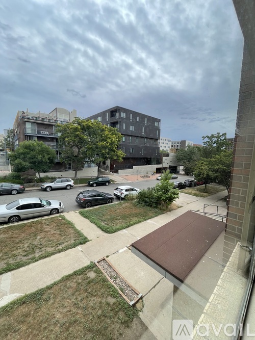 A parking lot with cars and a building in the background.