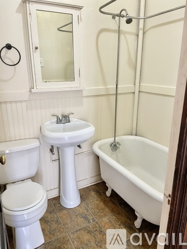 A white toilet and sink in a bathroom.