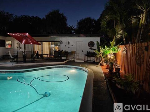 A pool with a hose in it and a house behind it.
