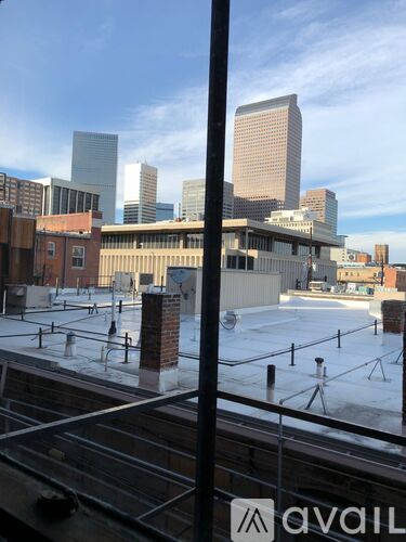 A view of a city skyline from a rooftop.