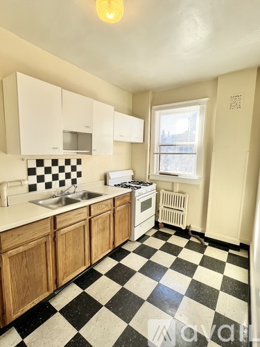 A kitchen with black and white checkered floor.
