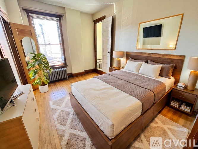 A bedroom with a large bed and a flat screen TV.