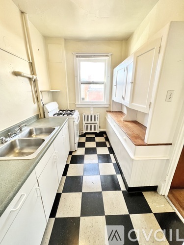 A black and white checkered floor in a kitchen.