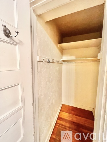A white door with a silver handle and a small window above it.