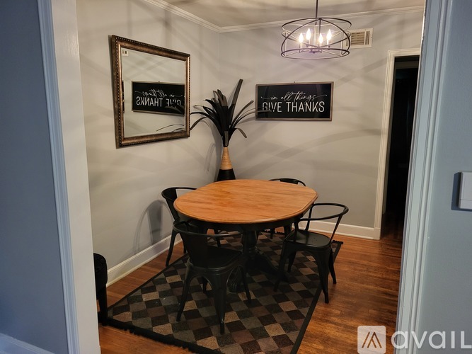 A dining room with a wooden table and chairs.