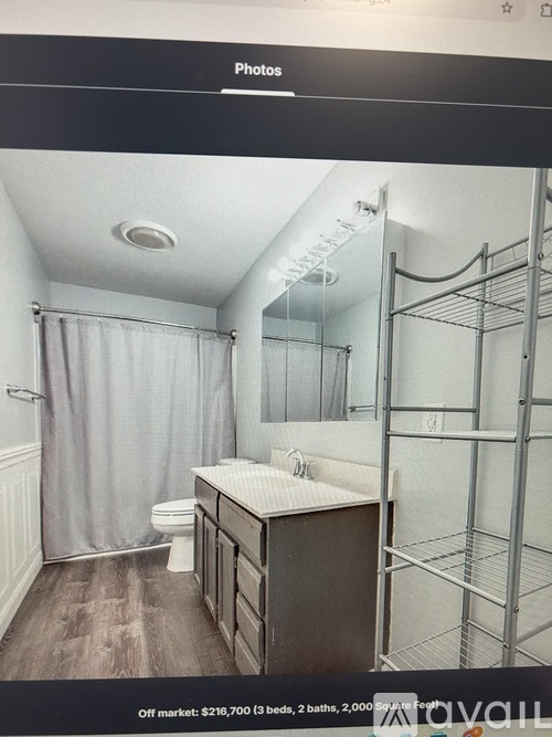 A bathroom with a toilet, sink, and shower.