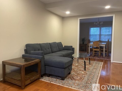 A living room with a grey couch and a wooden table.