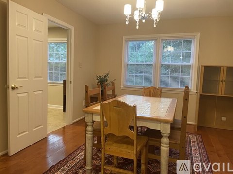 A dining room with a table and chairs.