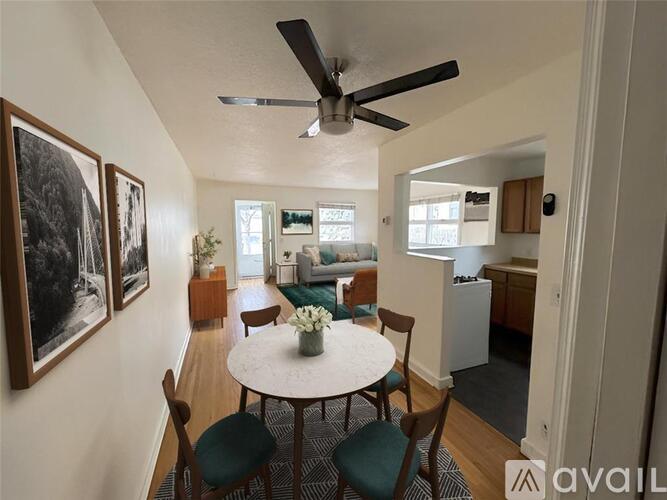 A living room with a dining table and chairs.