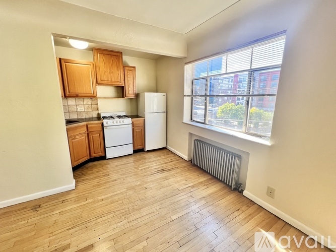 A kitchen with wooden cabinets and a white refrigerator.