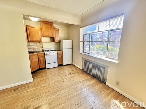 A kitchen with wooden cabinets and a white refrigerator.