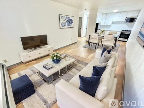 A modern living room with a white sofa and a coffee table.