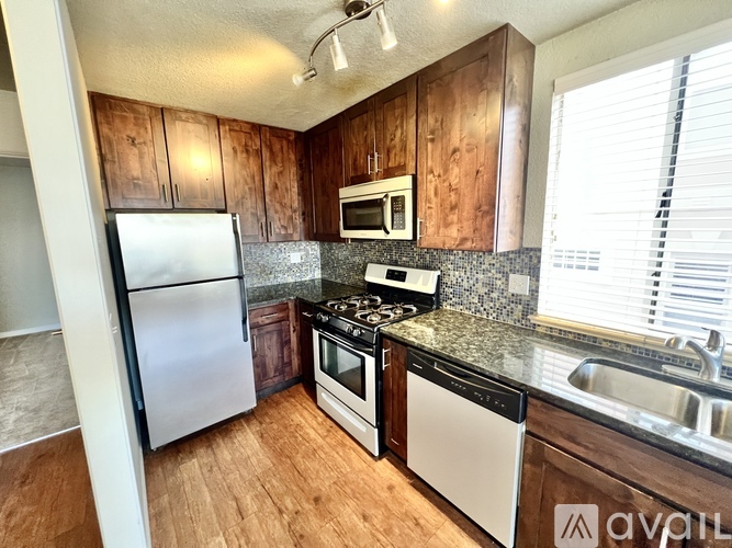 A kitchen with wooden cabinets and stainless steel appliances.