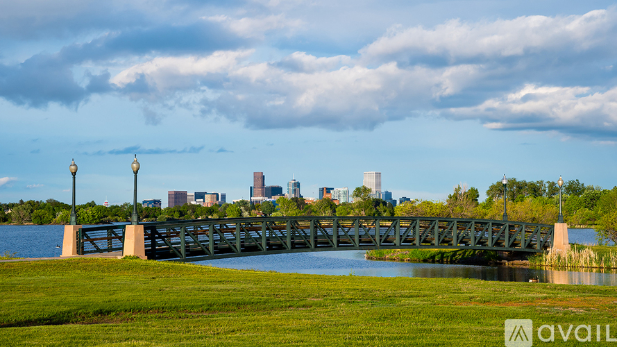 A bridge over a body of water with a city skyline in the background.