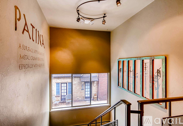 A hallway with a wall that says Patina on it.