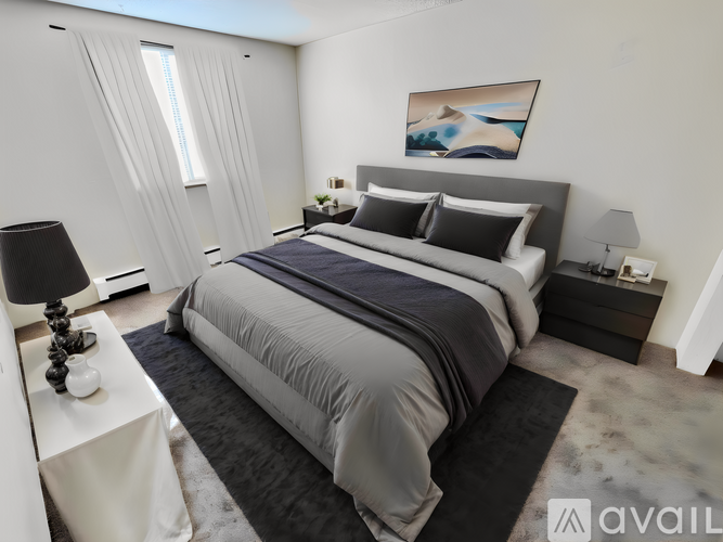 A modern bedroom with a large bed and a painting on the wall.
