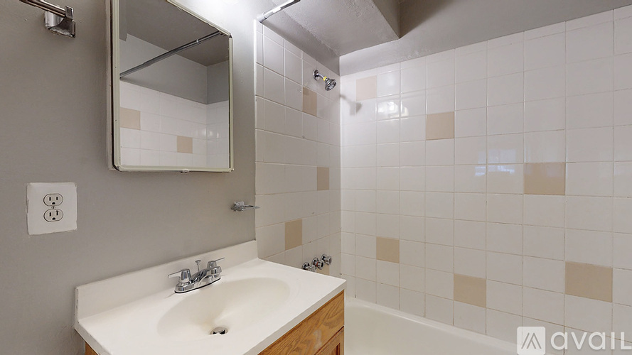 A bathroom with a sink and a mirror.