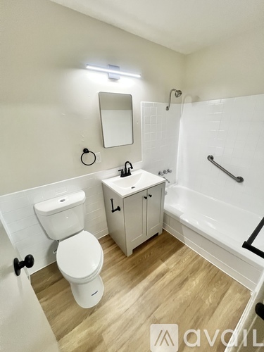 A white toilet sits next to a sink in a small bathroom.