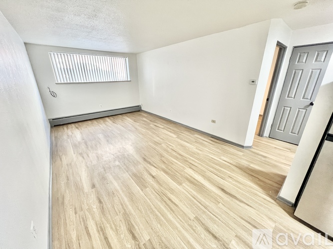 A room with wooden flooring and a closed door.