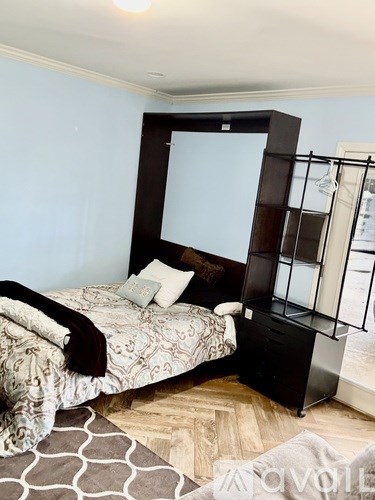 A bedroom with a large bed and a mirror on the wall.