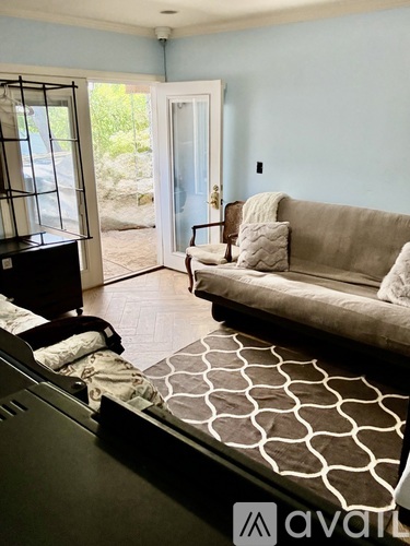 A living room with a couch and a bed.