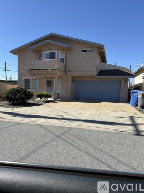 A two-story house with a garage is for sale.