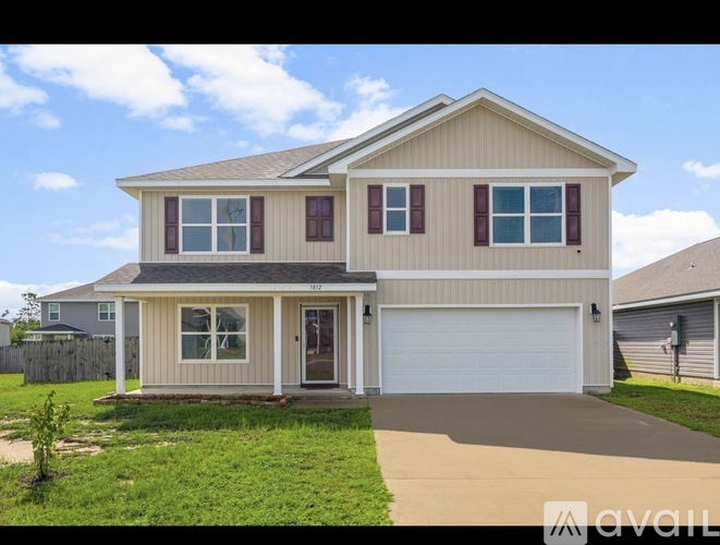 A two-story house with a garage is available for sale.