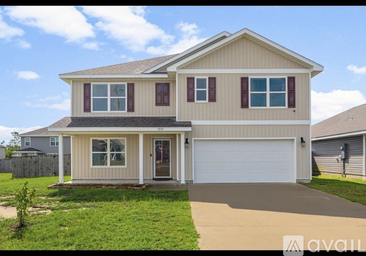 A two-story house with a garage is available for sale.