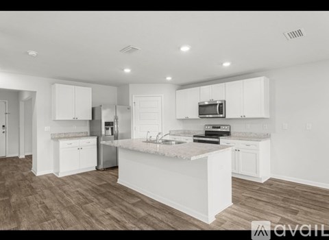 A modern kitchen with white cabinets and a central island.