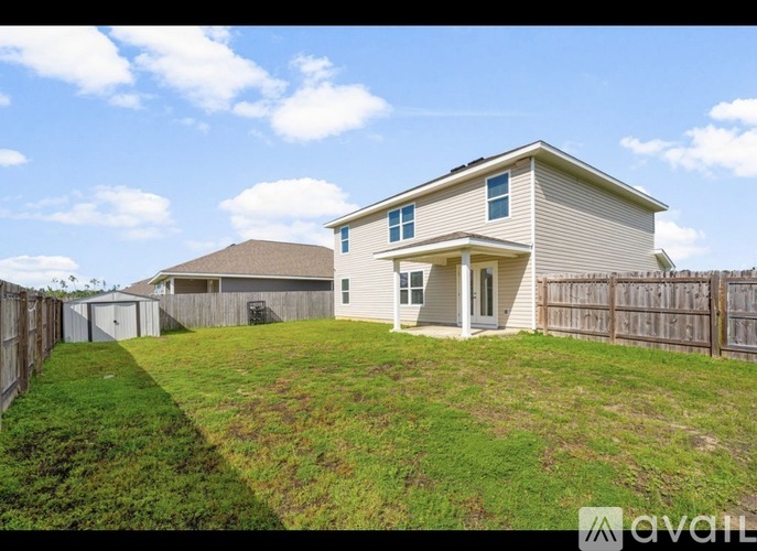 A house with a fence and a grassy yard is for sale.