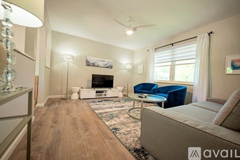 A living room with a blue couch and a television.