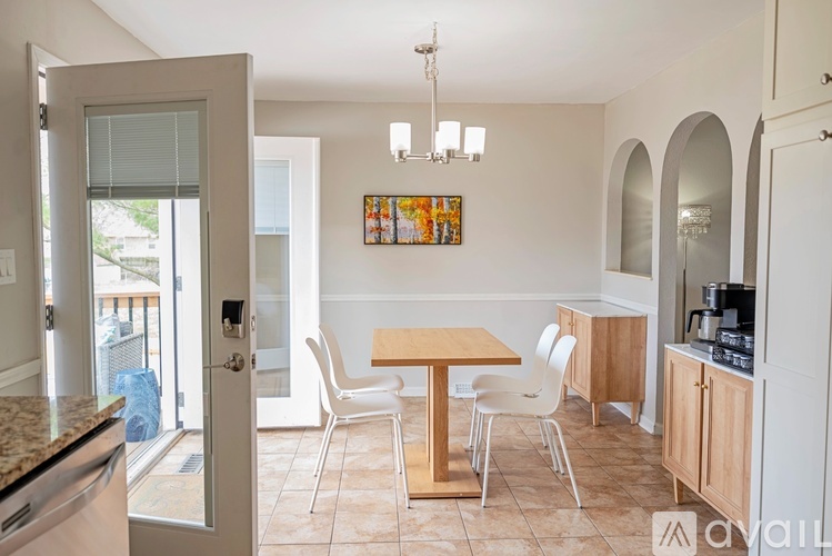 A kitchen with a table and chairs in the middle of the room.