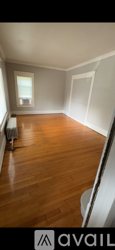 A room with wooden floors and a window.