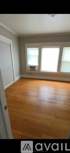 A room with wooden floors and white walls.