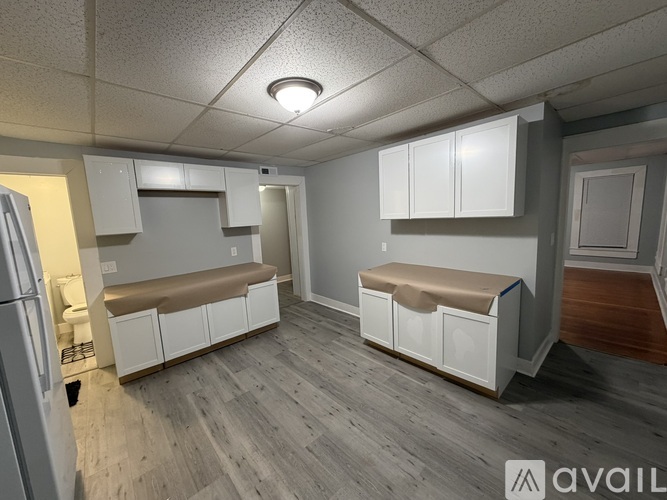 A kitchen with white cabinets and a bench seat.