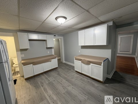 A kitchen with white cabinets and a bench seat.