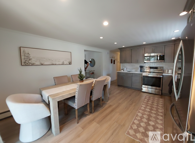 A modern kitchen with a dining table and chairs.