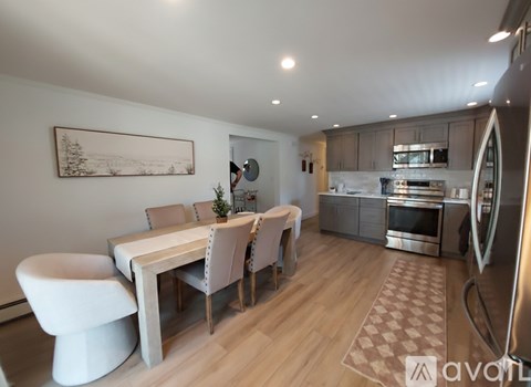 A modern kitchen with a dining table and chairs.