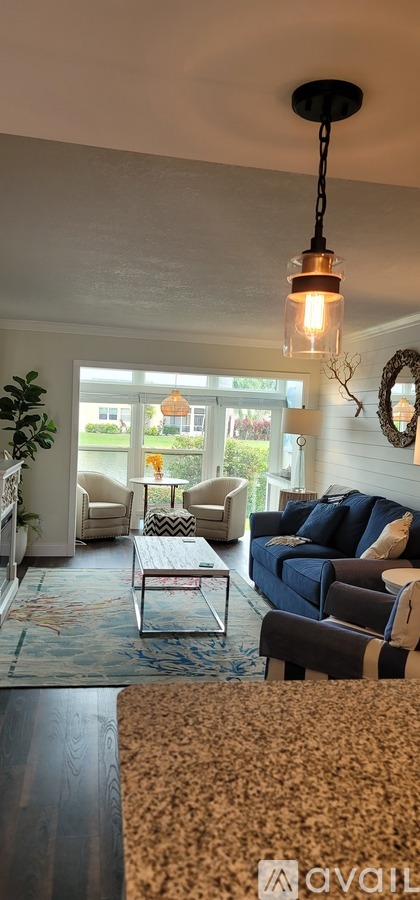 A living room with a couch, chairs, and a coffee table.